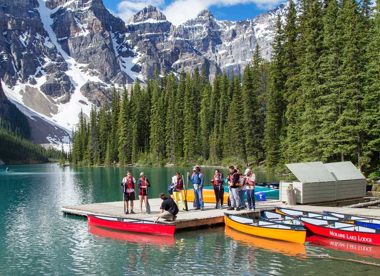 Picture of people barding canoes on moraine lake.