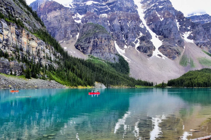 People in a canoe, view from the Lakeshore Trail at Moraine Lake.