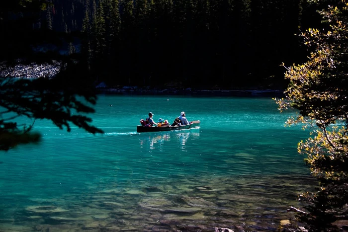 Family in a canoe, in Moraine Lake's turquoise waters.